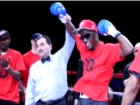 Boxing judge raising Black boxer's glove for victory